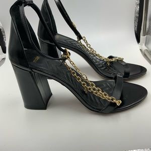 Maje black heeled sandals with removable gold chain.